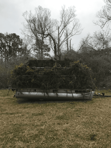 Pontoon boat woth vegetation camoflouge 