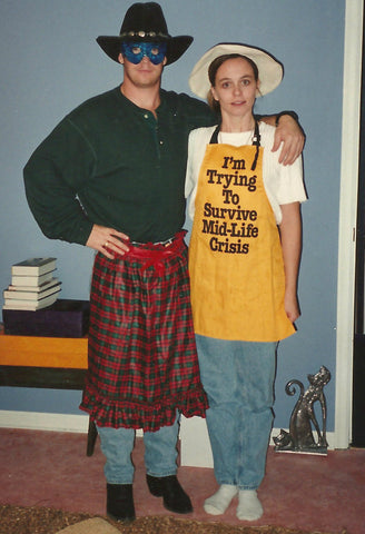 Young couple posing with silly clothes on and apron about a mid life crises