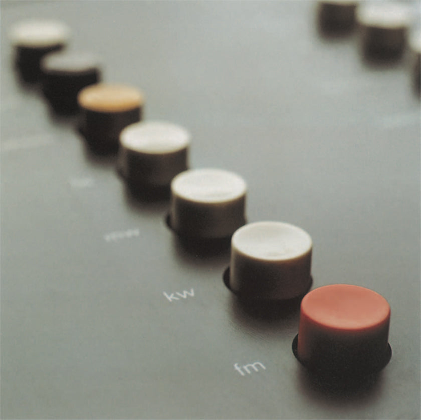 Close up image of color coded buttons of a hi-fi system by Braun. (Design by Dieter Rams, photography by Timm Rautert)