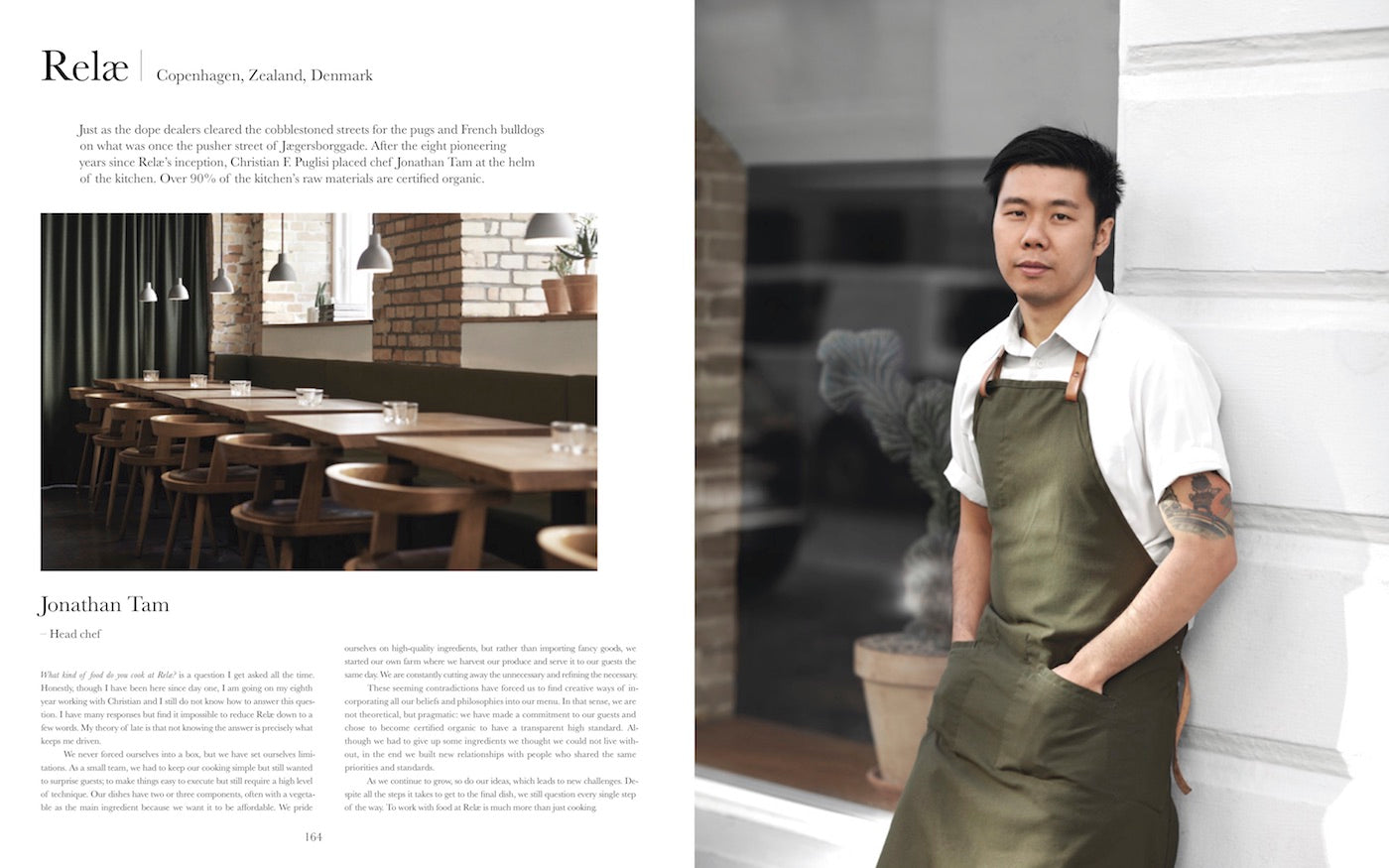 Head chef of Relæ Restaurant Jonathan Tam standing, wearing his cooking uniform and a green apron. (Photo: Michael Jepsen)