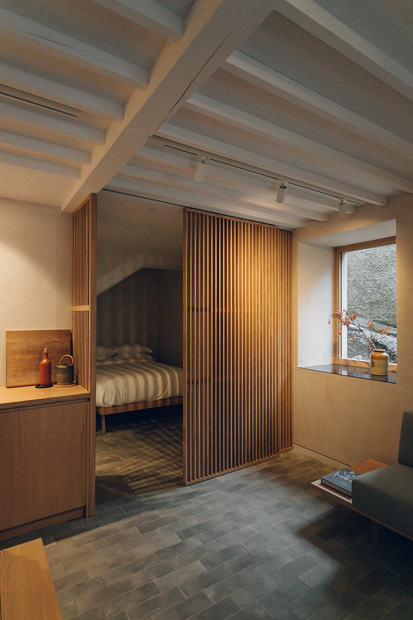 Kitchen and bed partly visible in a studio designed by Izat and Arundell in Edinburgh. (Photo: Haarkon)