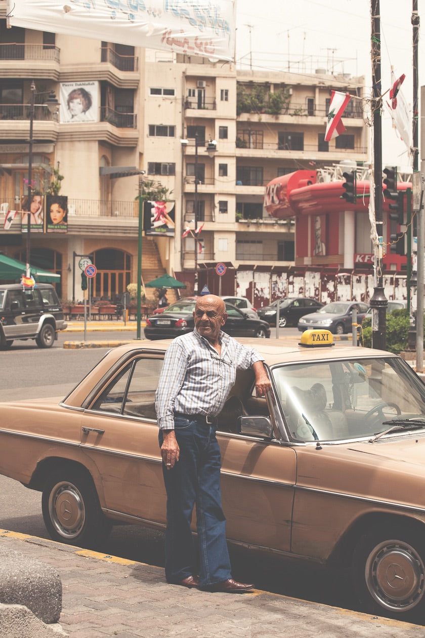 Taxi driver standing in front of and old Mercedes Benz taxi on the streets of Beirut, Lebanon. (Photo: Monocle)