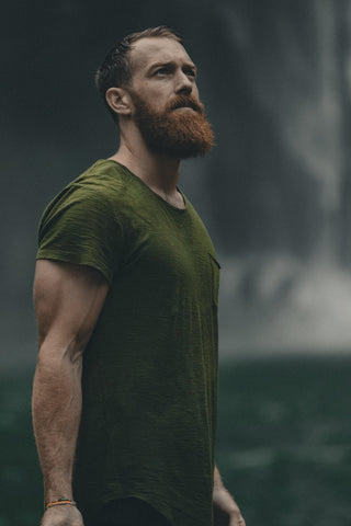 A man with a beard looking upwards.