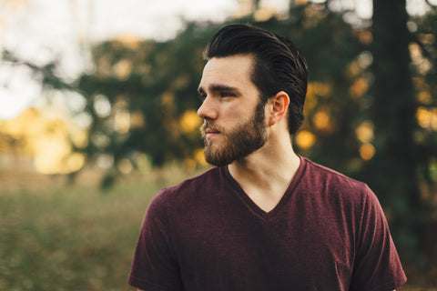 A man with a soft beard looking into the distance.