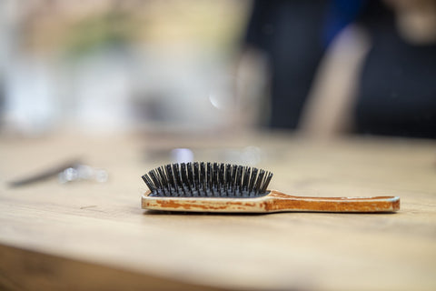 A brush lying on a wooden table