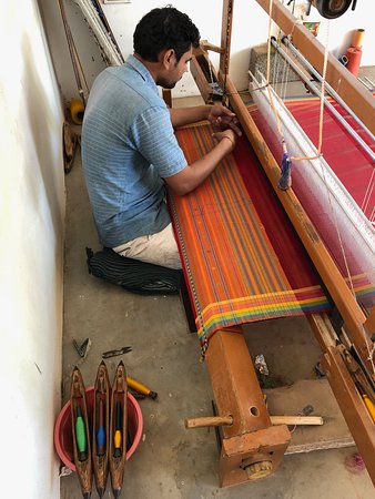 Handweaving on wooden handloom india