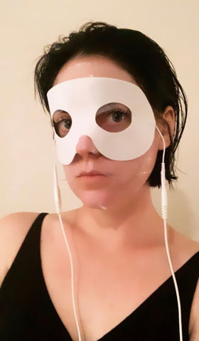 The Organic Esthetician using a sheet mask with conductive eye mask from 7e wellness