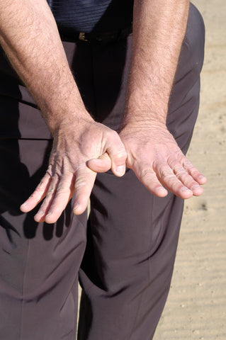 Man with hands spread out and interlocking thumbs