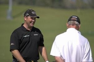 John Bickerton laughing with a man in a white top.