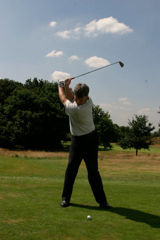 David Wilkinson swinging his golf club back over his shoulder and head.