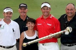 Lee Westwood holding a trophy standing with three men and one woman