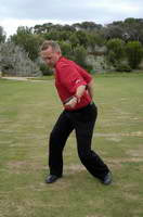 Ramsay McMaster demonstrating poor rotation sequencing with a golf club behind his back