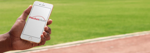 Person holding phone with pocketshots logo and grass background