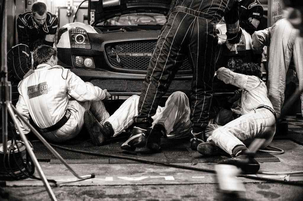 “This image shows a Spa 24 Hours race in 2011, where everyone in the whole team is working on the car to get it back out again. It took two hours to fix, but completed the 24 Hour race.” Photo by Lara Platman.