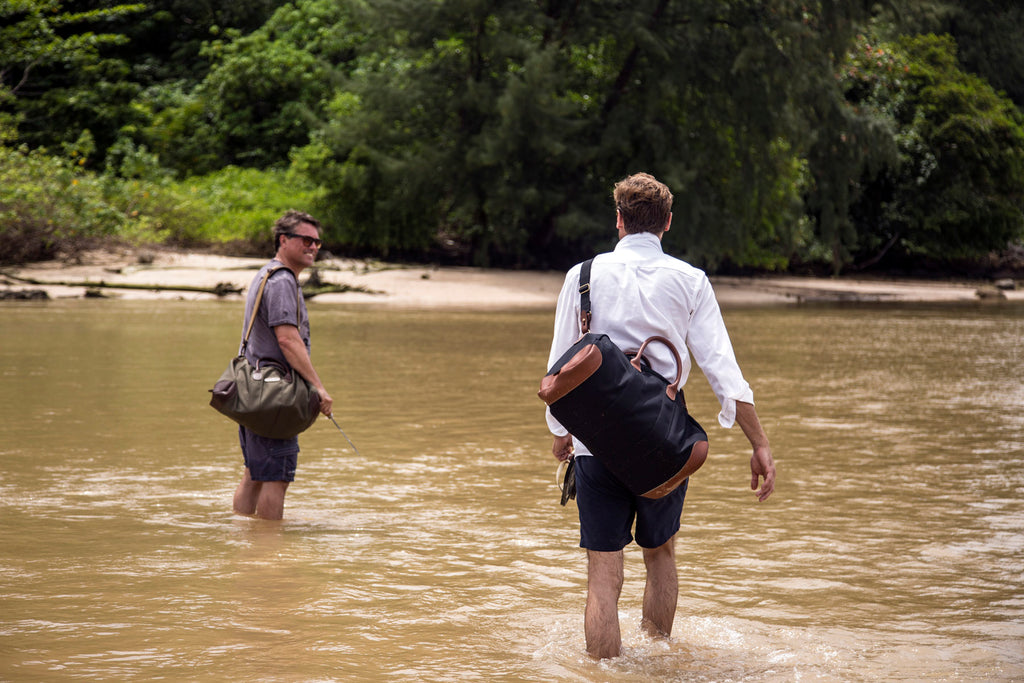 Russ Malkin & Charley Speed wading through a river crossing with their Billingham Weekenders.