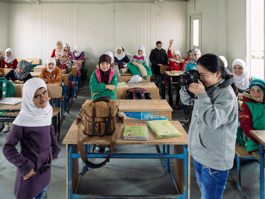 Paddy Dowling holds a photography lesson at school in Zaatari refugee camp for children who have fled Syria. Bag pictured is a Billingham 207.