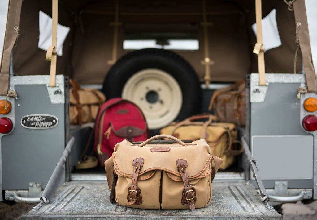 1964 Series 2a Land Rover with Billingham Billingham Hadley Pro bag (front), Rucksack 35 in Burgundy Canvas and Chocolate Leather (centre left), 550 bag (rear left), Billingham 225 bag (centre right) and old Billingham System bag (rear right). Photo by Lara Platman.