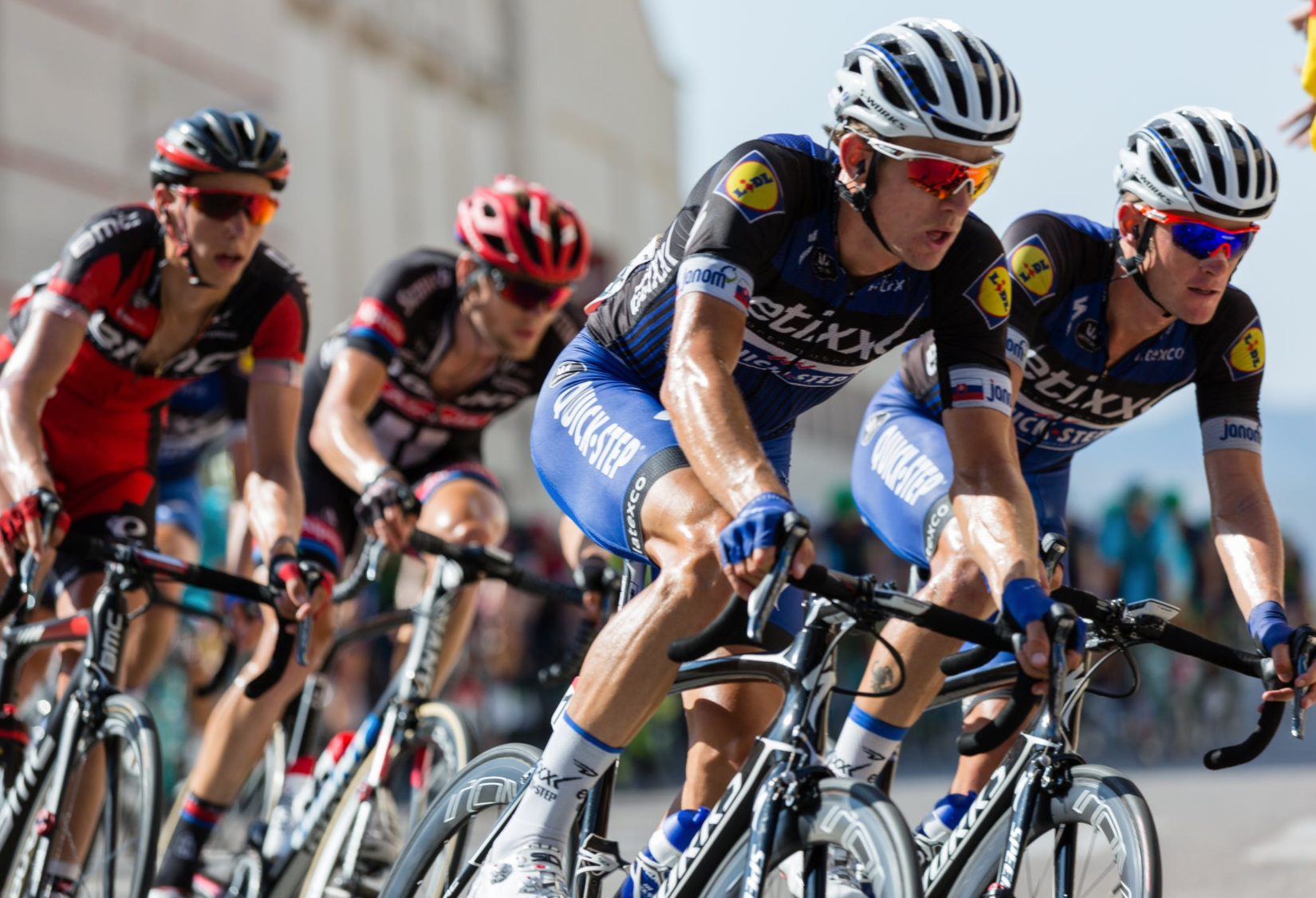 Cyclists fueled with hydrolyzed collagen peptides are pedaling through a sun-drenched road on a competitive cycling race day