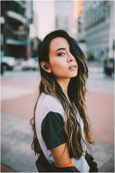Girl With xFyro earbuds