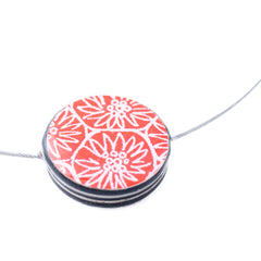 a necklace made from paper and resin