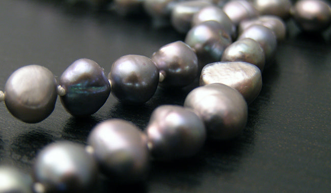 closeup dark pearl necklace