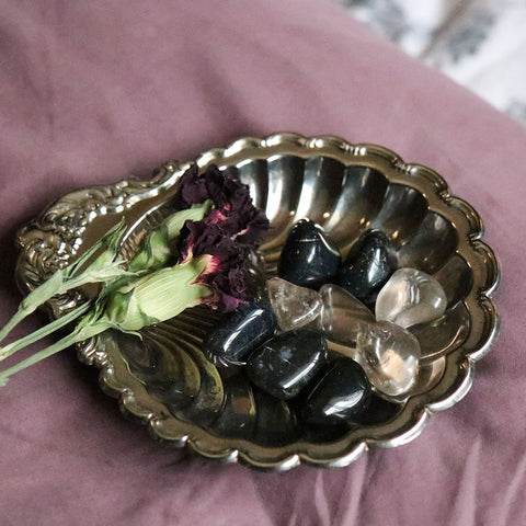 A Silver Dish with Tumbled Black Onyx and Smokey Quartz on it