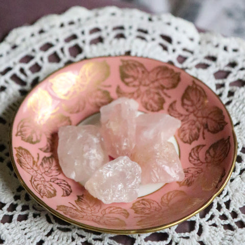A vintage Pink Saucer with small Raw Pieces of Rose Quartz on it
