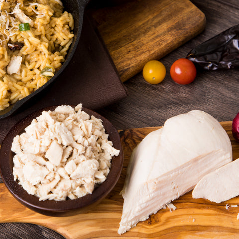 Delicious, freeze-dried chicken spread across a wood cutting board.