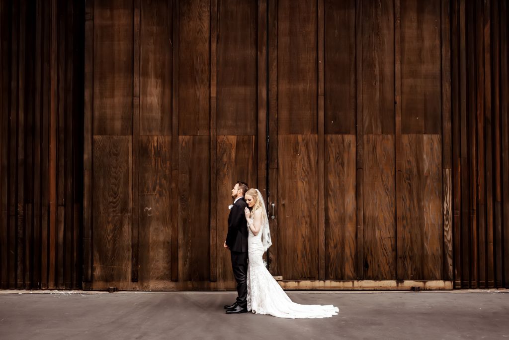 woodsy boho wedding with bride in lace sheath dress and short veil