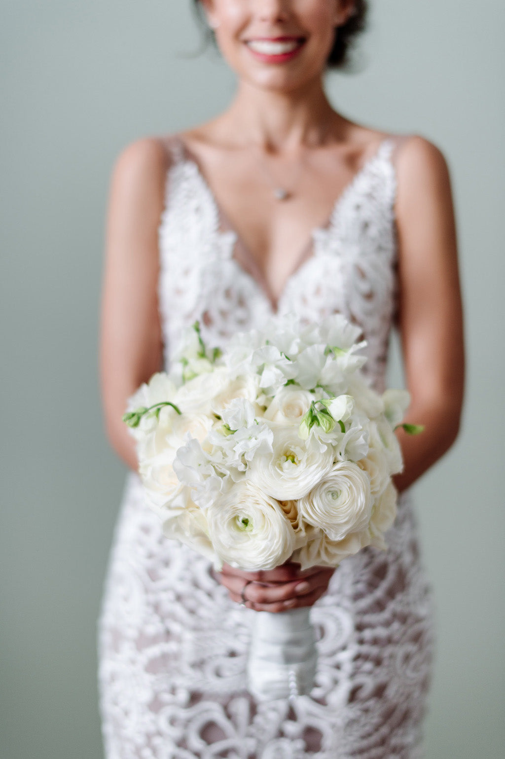 Bride holding white bridal bouquet wedding flowers