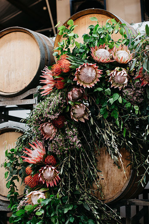 Wedding Flowers in front of barrels