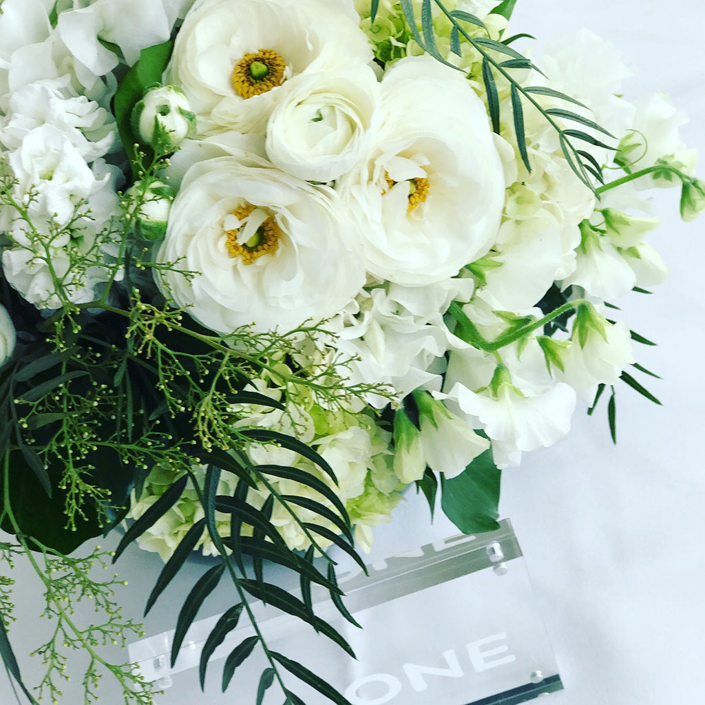 Table centrepiece of white wedding flowers