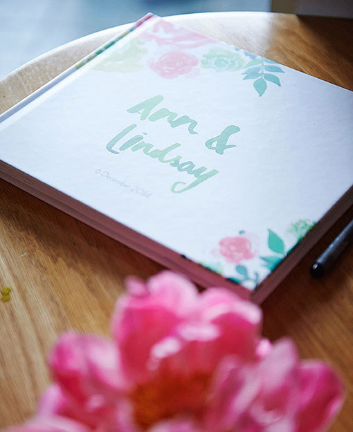 Welcome book with peony wedding flowers