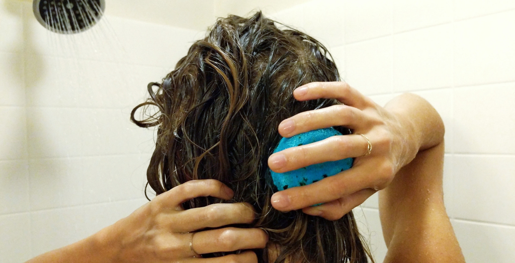 Girl washing hair with shampoo bar