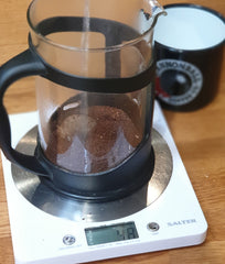 pouring water over freshly ground coffee in a cafetiere