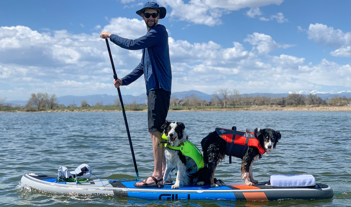 Best paddle board for dogs - man and two dogs