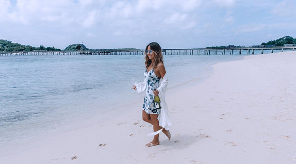 This Island Life walking on a beach in the London Print Slip and Ivory Silk Cotton Robe