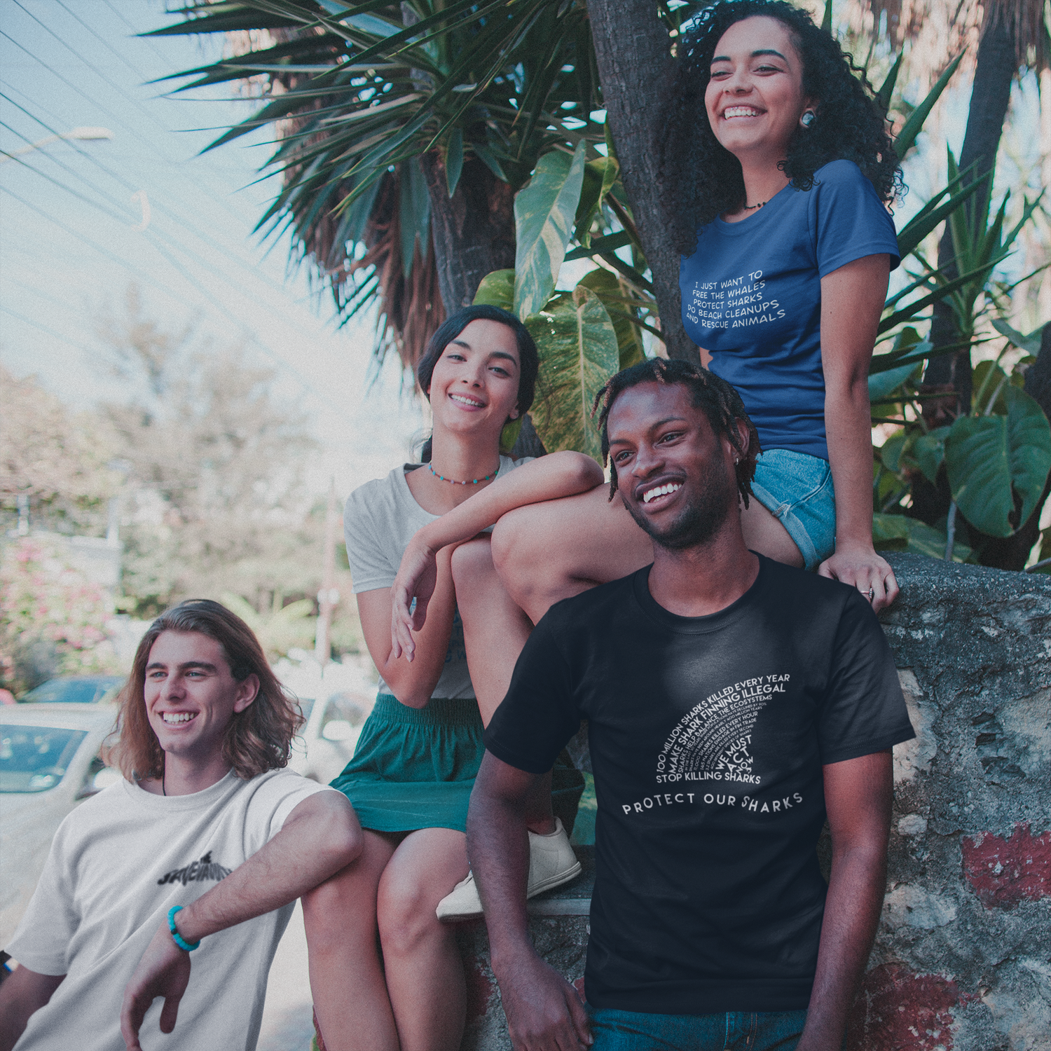 group of friends smiling while wearing sweetsherriloudesigns shirts - ethically and sustainably made products that give back to non-profit organizations