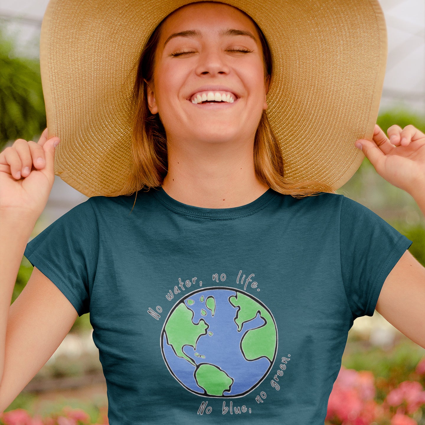 girl in greenhouse with flowers and sunhat wearing getpinkfit "No Blue No Green" tshirt - 10% of profits give back to non-profit organizations - ethically and sustainably made clothing