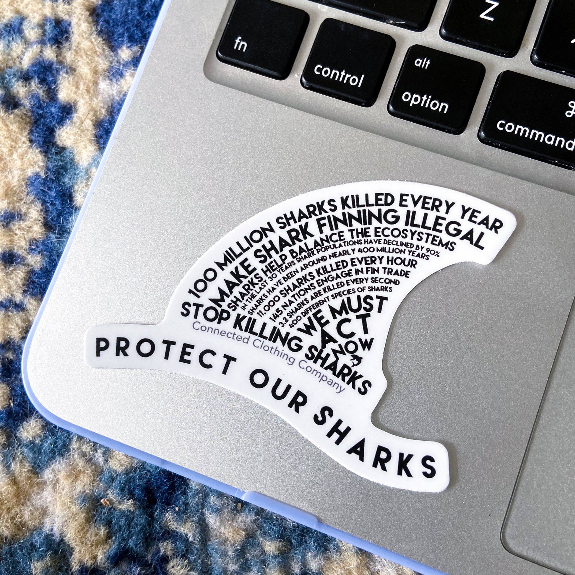getpinkfit Protect Our Sharks Sticker on Macbook for size reference.