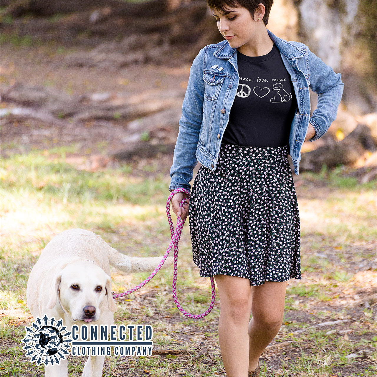 Model Walking Dog While Wearing Black Peace Love Rescue Short-Sleeve Tee - sweetsherriloudesigns - Ethically and Sustainably Made - 10% donated to Villalobos Animal Rescue Center