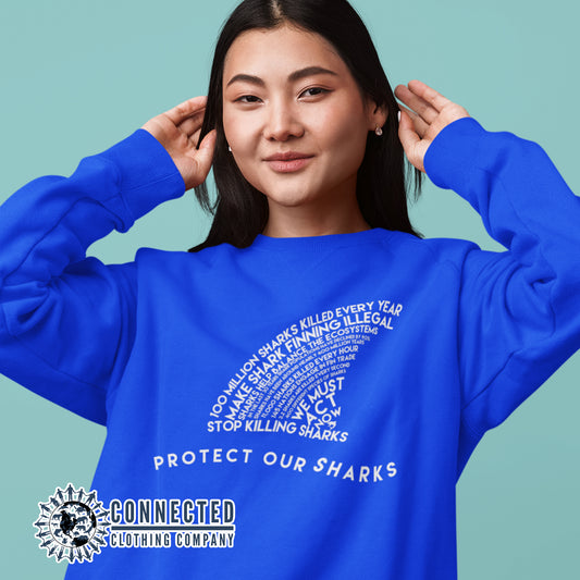 Model Wearing Royal Blue Protect Our Sharks Unisex Crewneck Sweatshirt - getpinkfit - Ethically and Sustainably Made - 10% of profits donated to shark conservation and ocean conservation