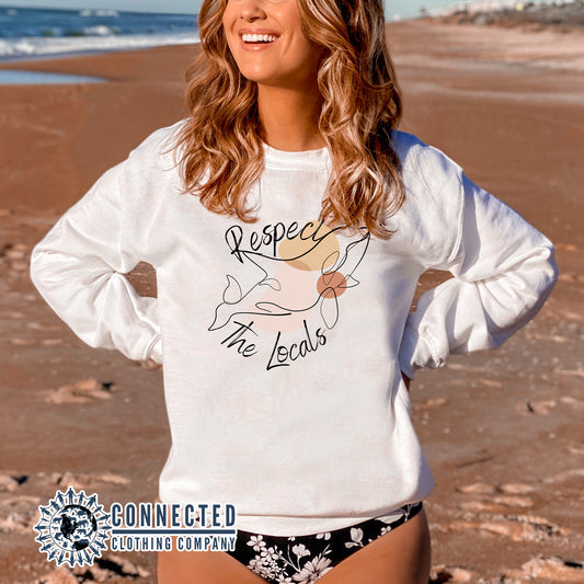 Model Wearing White Respect The Locals Orca Unisex Crewneck Sweatshirt - getpinkfit - Ethically and Sustainably Made - 10% of profits donated to ocean conservation