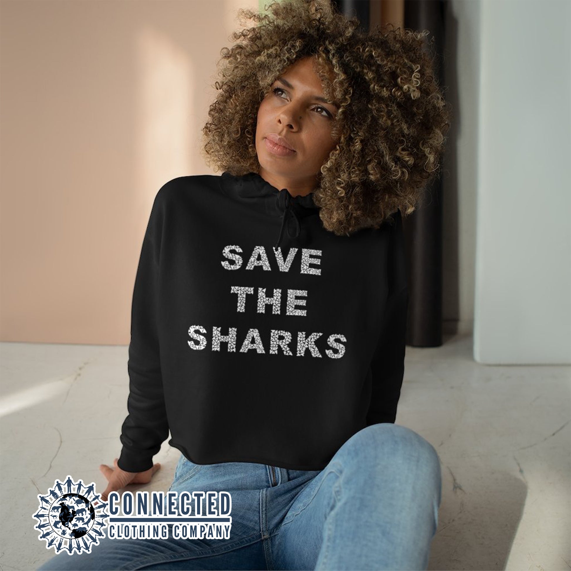 Model Wearing Black Save The Sharks Crop Hoodie - sweetsherriloudesigns - Ethically and Sustainably Made - 10% donated to Oceana shark conservation