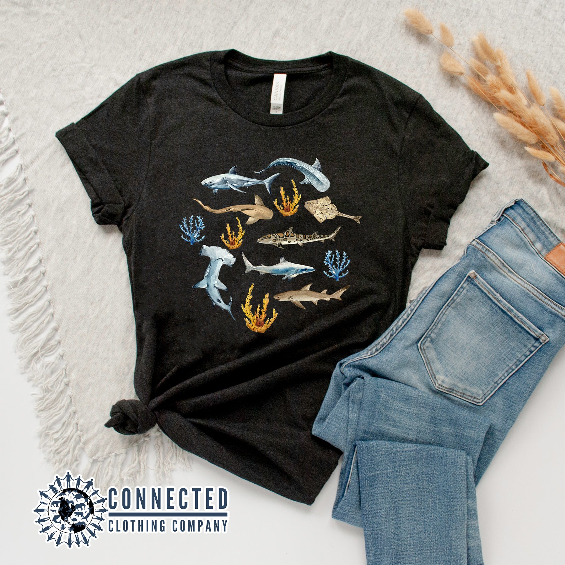 Flatlay of Black Shark Ocean Watercolor Unisex Short-Sleeve Tshirt - sweetsherriloudesigns - Ethically and Sustainably Made - 10% of profits donated to shark conservation and ocean conservation