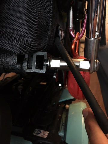 Button head screw inserted into t-slot of Invacare TDX SP2 power wheelchair