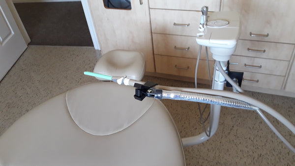 SnakeClamp flexible gooseneck arm supporting suction device in dental office