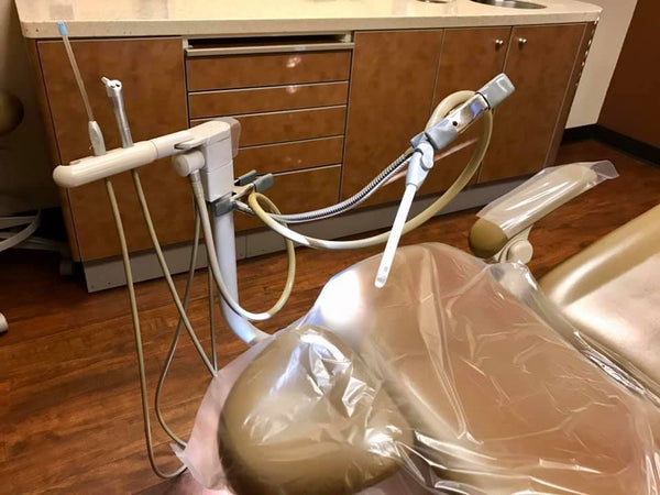 SnakeClamp supporting a suction device in a dental chair