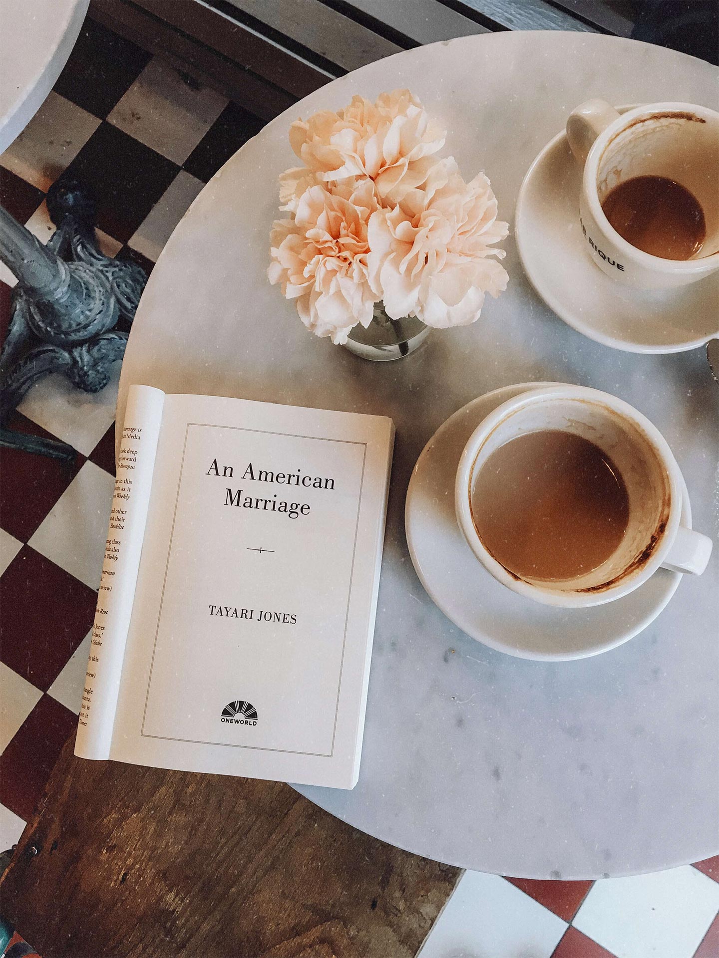 an American marriage read at a coffee table with a bouquet of flowers