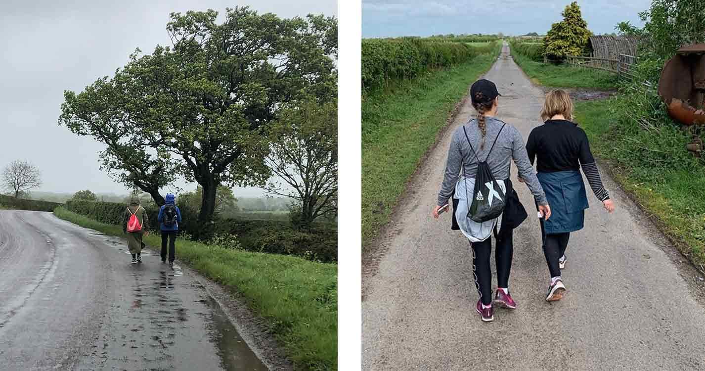 two-women-walking-down-a-narrow-road-next-to-a-hedge-in-sportswear-training-for-the-moonwalk-2019